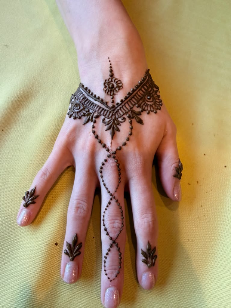 Paisley henna design along the forearm